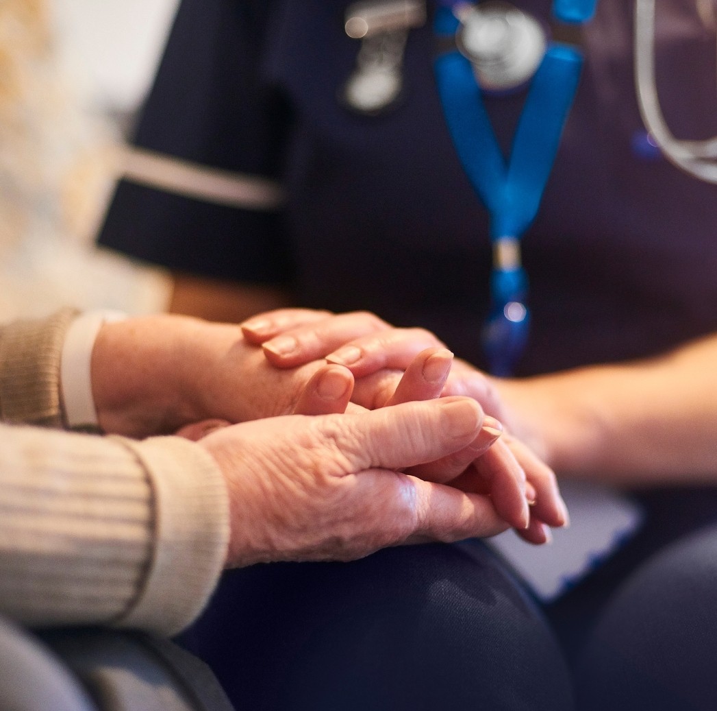 nurse's hands holding patient hands.jpg